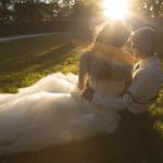 Bride and groom kissing in sunlight
